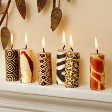 five candles are lined up on a mantle