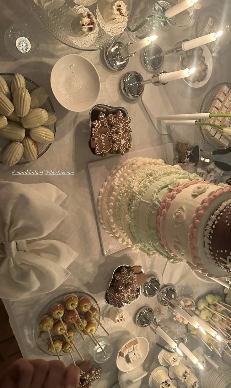 a table topped with lots of desserts and plates