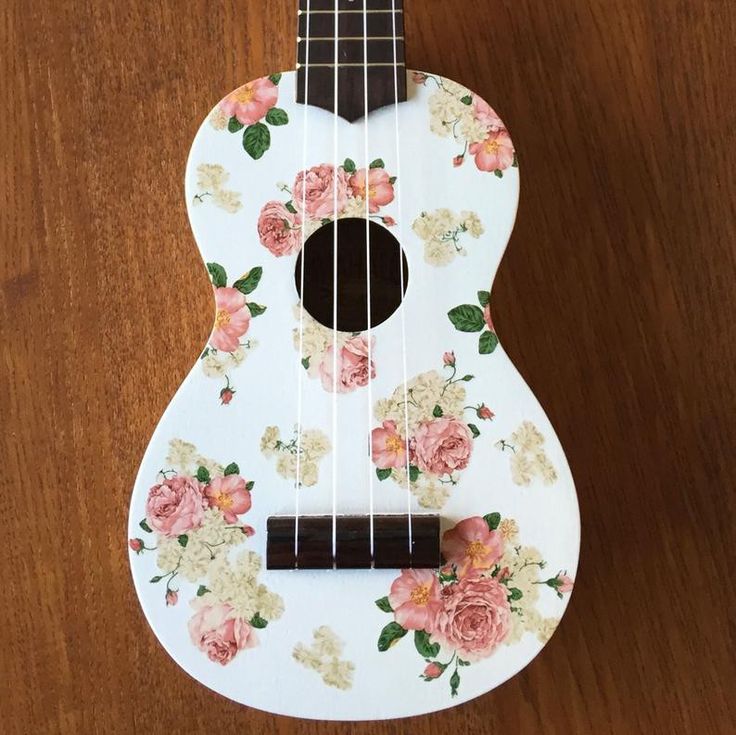 a ukulele with flowers painted on it