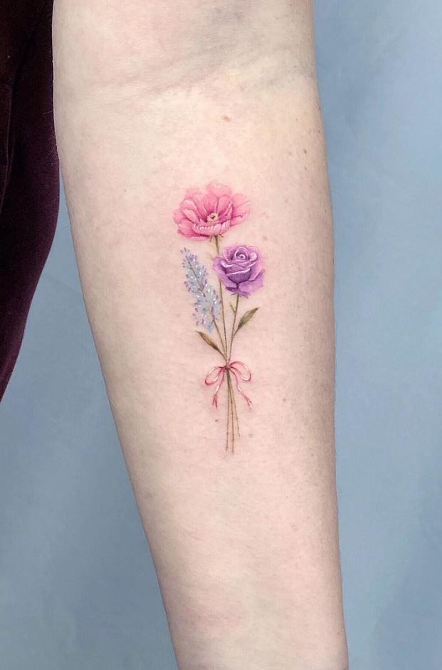 a woman's arm with three flowers on it