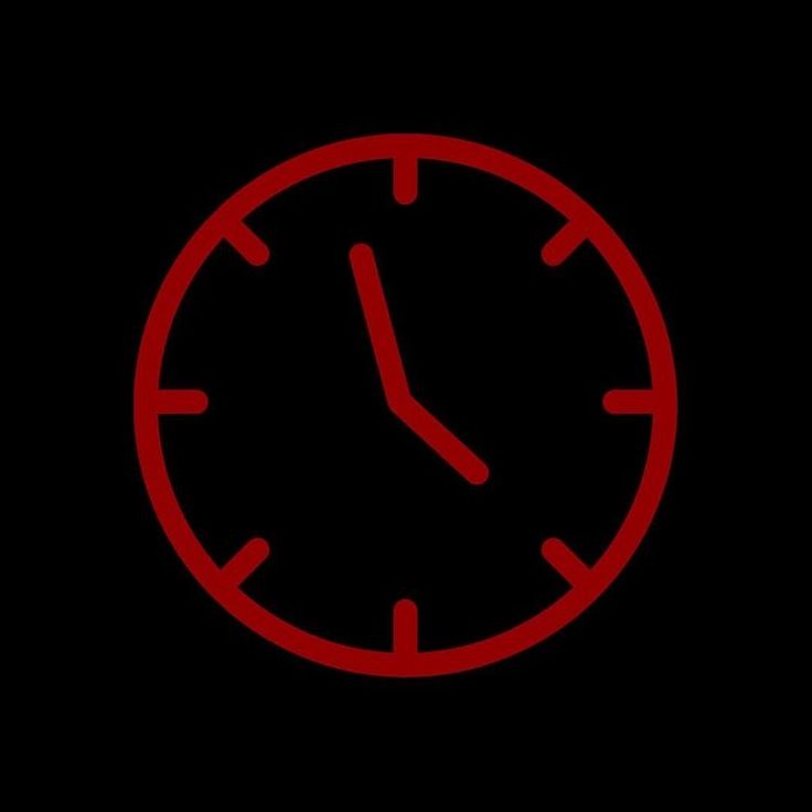 a red clock on a black background with the time at 11 00 pm in the middle