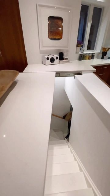 a white counter top sitting inside of a kitchen