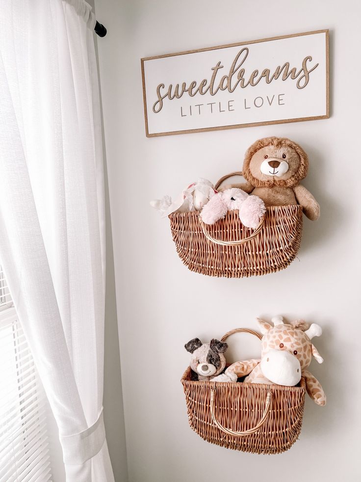 two baskets with stuffed animals hanging on the wall