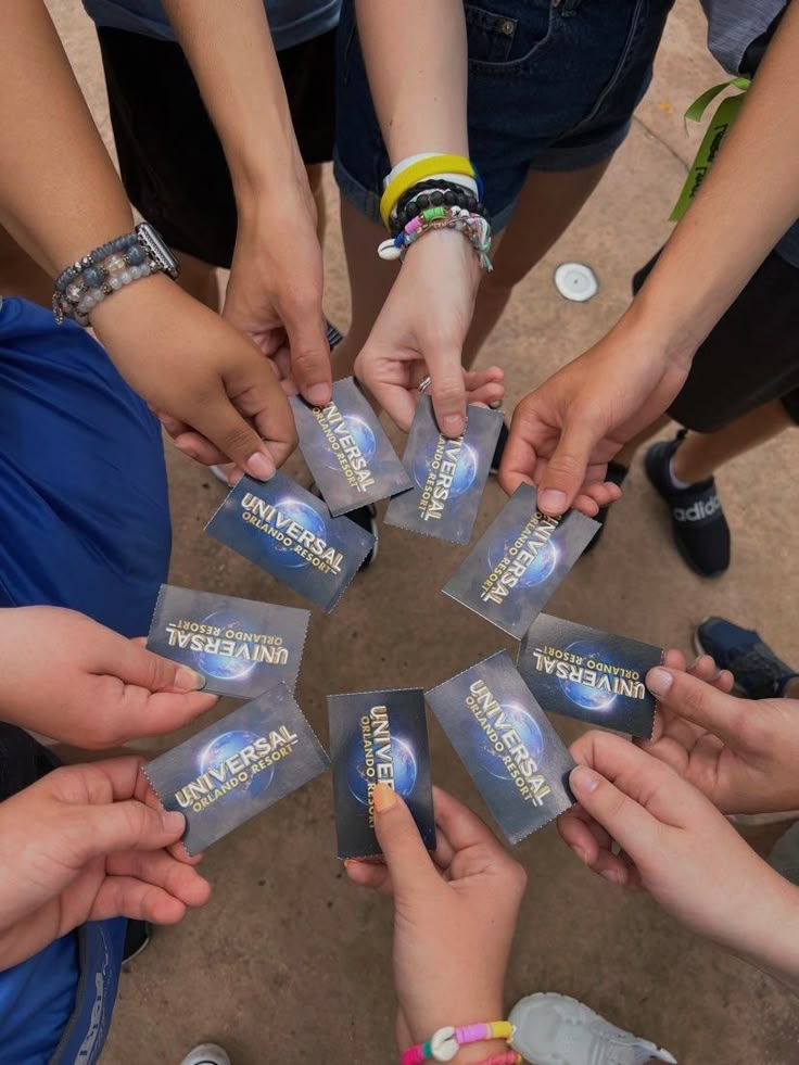 several people holding their hands together in a circle