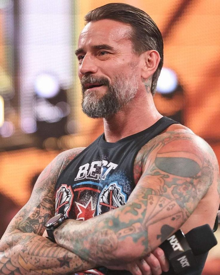 a man with tattoos on his arms and chest