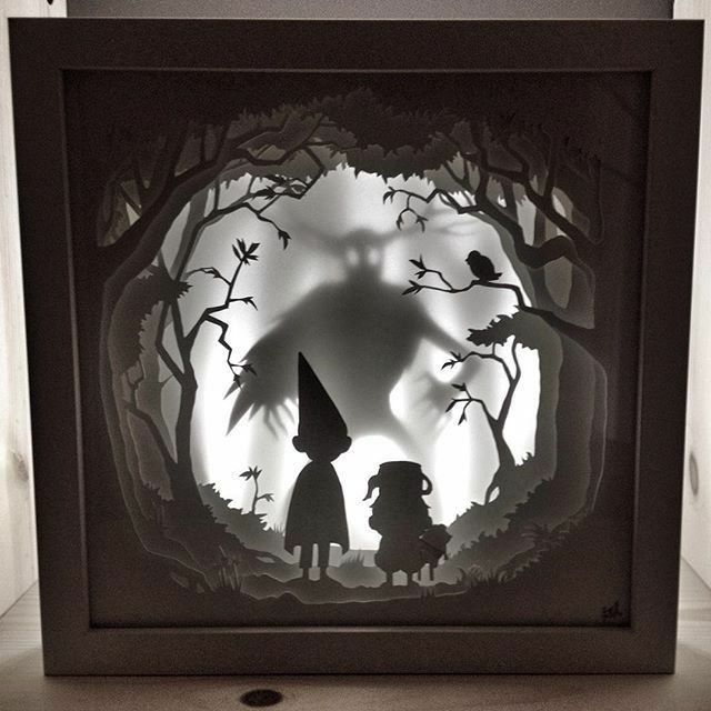 an image of a paper cut out of the shape of a wizard and her child