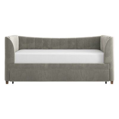 a gray couch sitting on top of a white floor