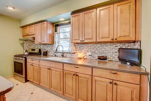 a kitchen with wooden cabinets and tile backsplash