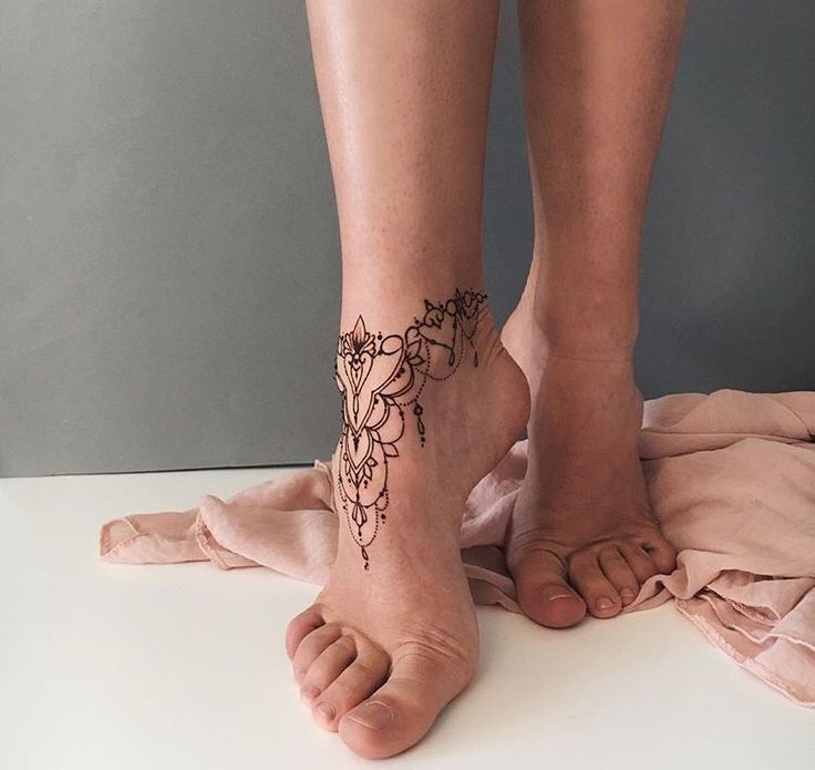 two people with tattoos on their feet and one has a cat tattoo on her leg