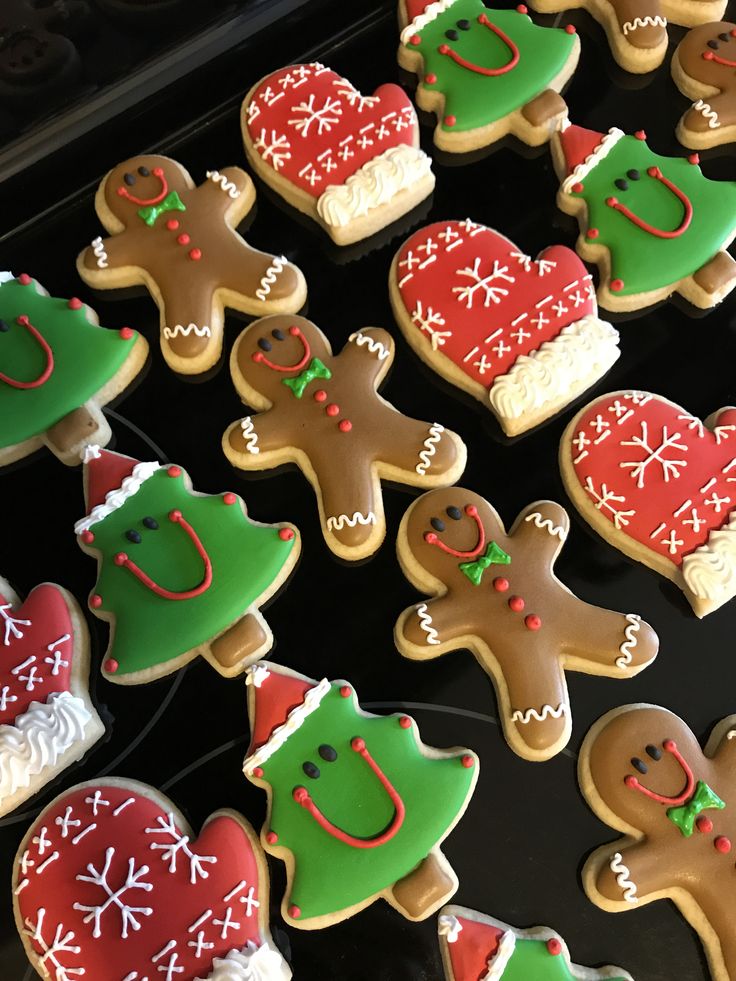 many decorated cookies in different shapes and colors