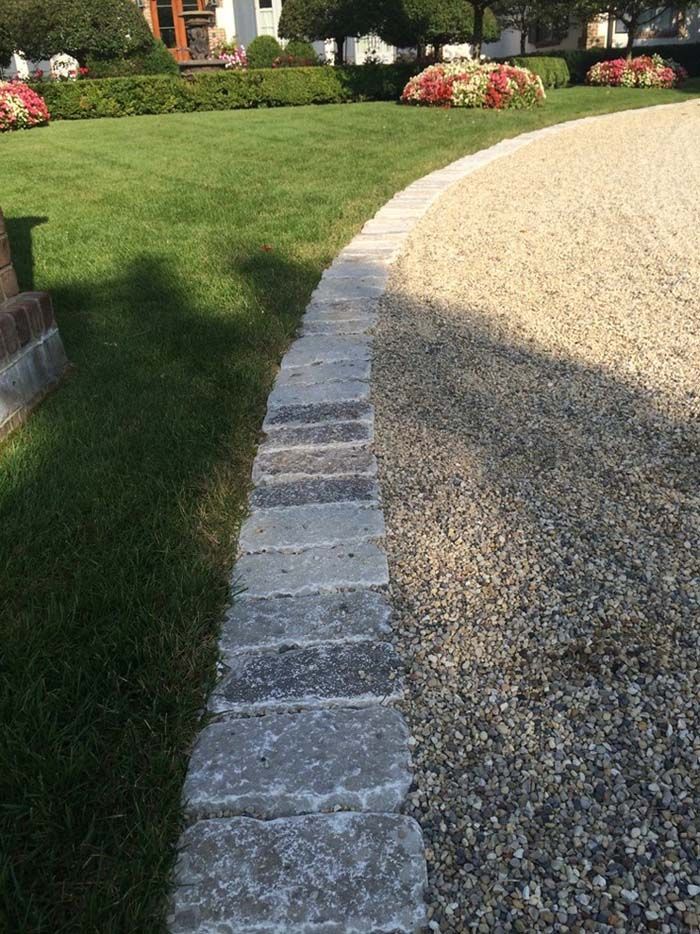 a stone path in front of a house