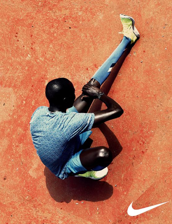 a person sitting on the ground with a baseball bat in their hand and one foot up