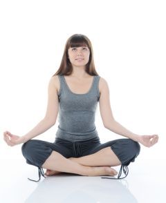 a woman sitting in the middle of a yoga pose