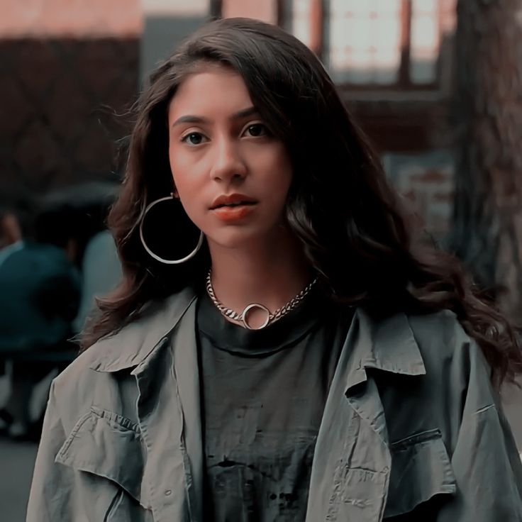 a woman with large hoop earrings on her neck