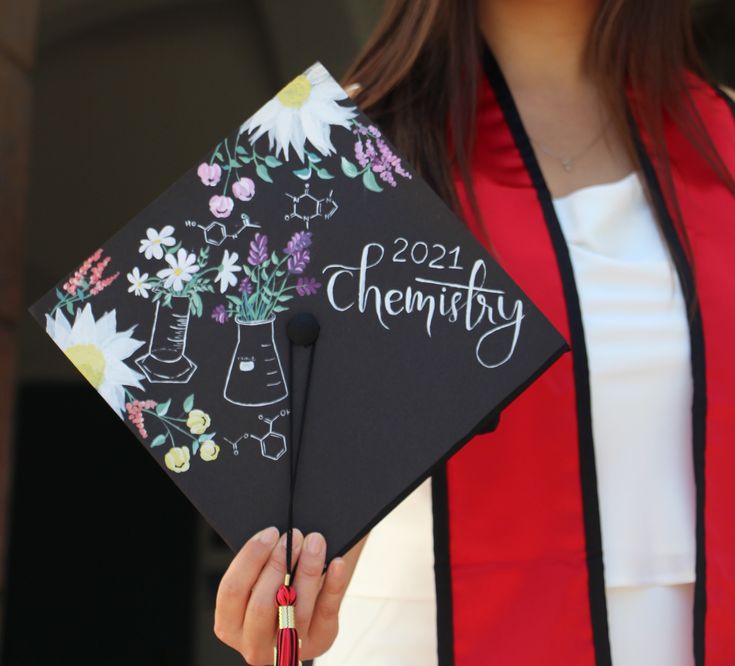 a woman is holding a graduation cap with flowers on it and the words,'2021himfy '