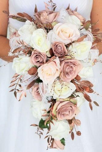 a bridal holding a bouquet of pink and white flowers