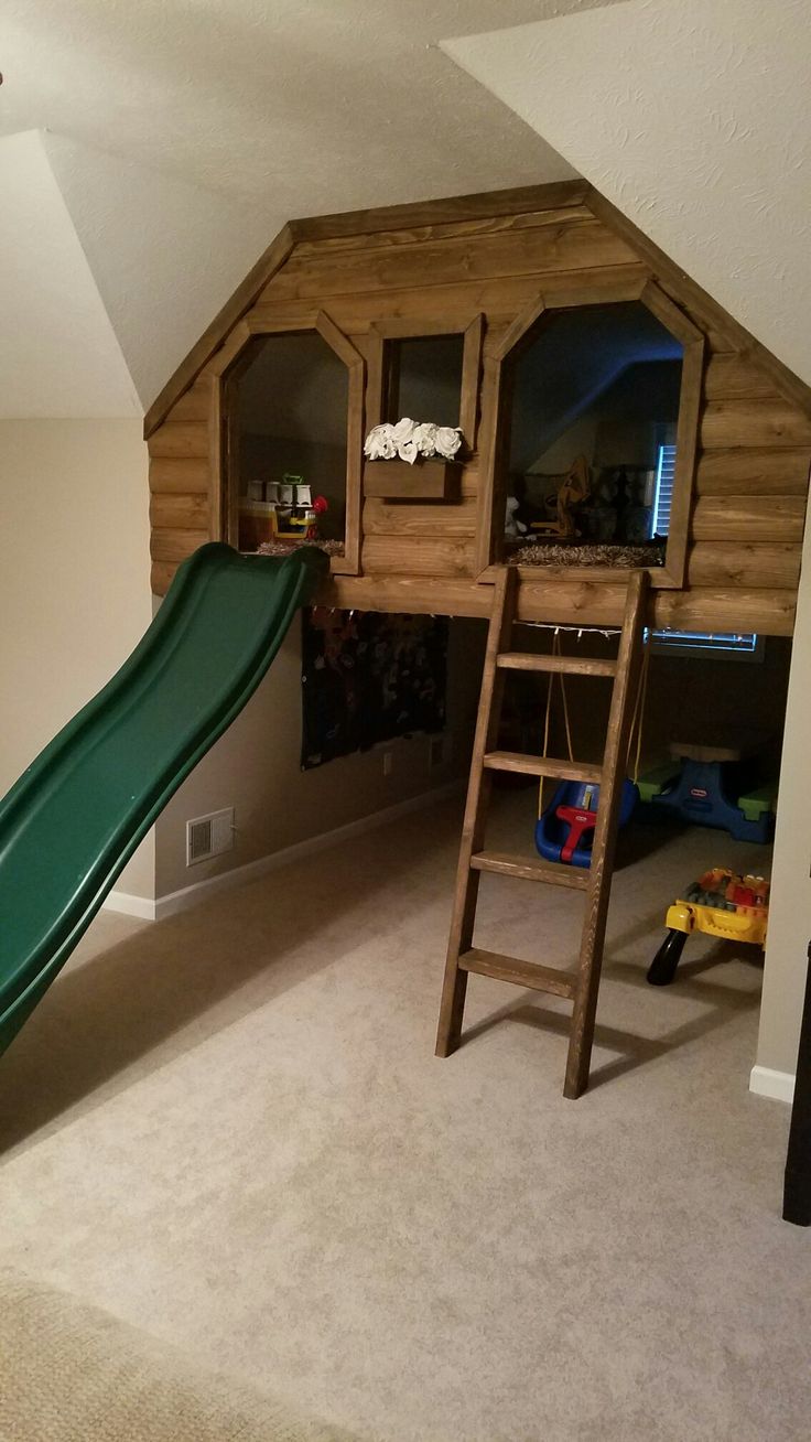 a child's play area with a slide and bunk bed in the corner,