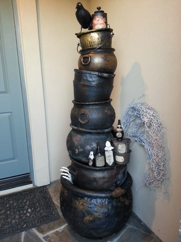 a stack of pots sitting on top of each other in front of a door way