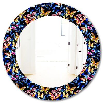 a round mirror with butterflies on it