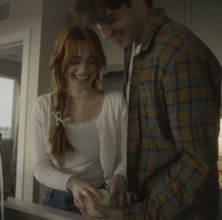 a man and woman standing in front of a counter