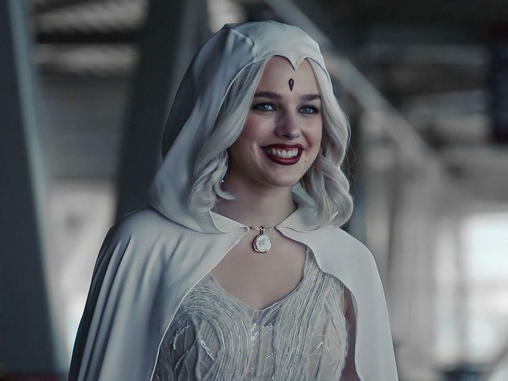 a close up of a person wearing a nun costume and smiling at the camera with an evil look on her face