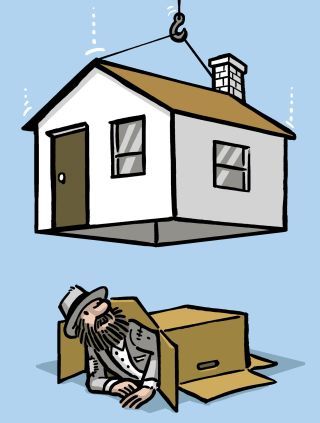 a man laying on the ground next to a box with a house hanging from it