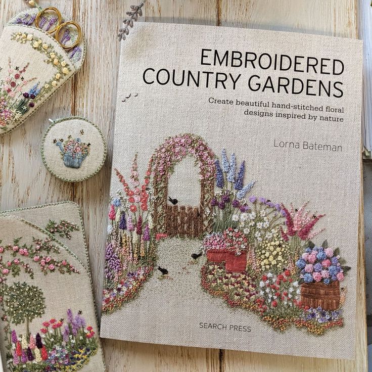 embroidered country gardens book on wooden table