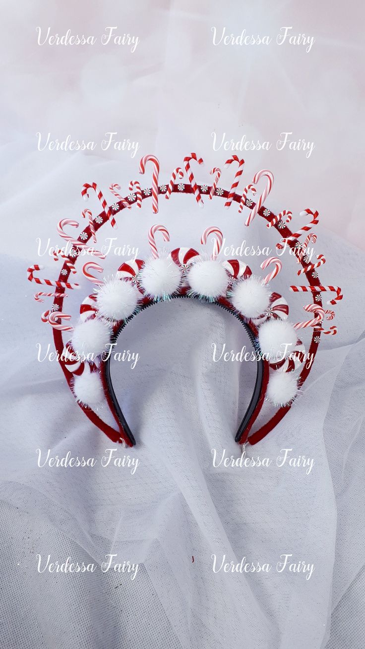 a red and white christmas headband with candy canes on it's side