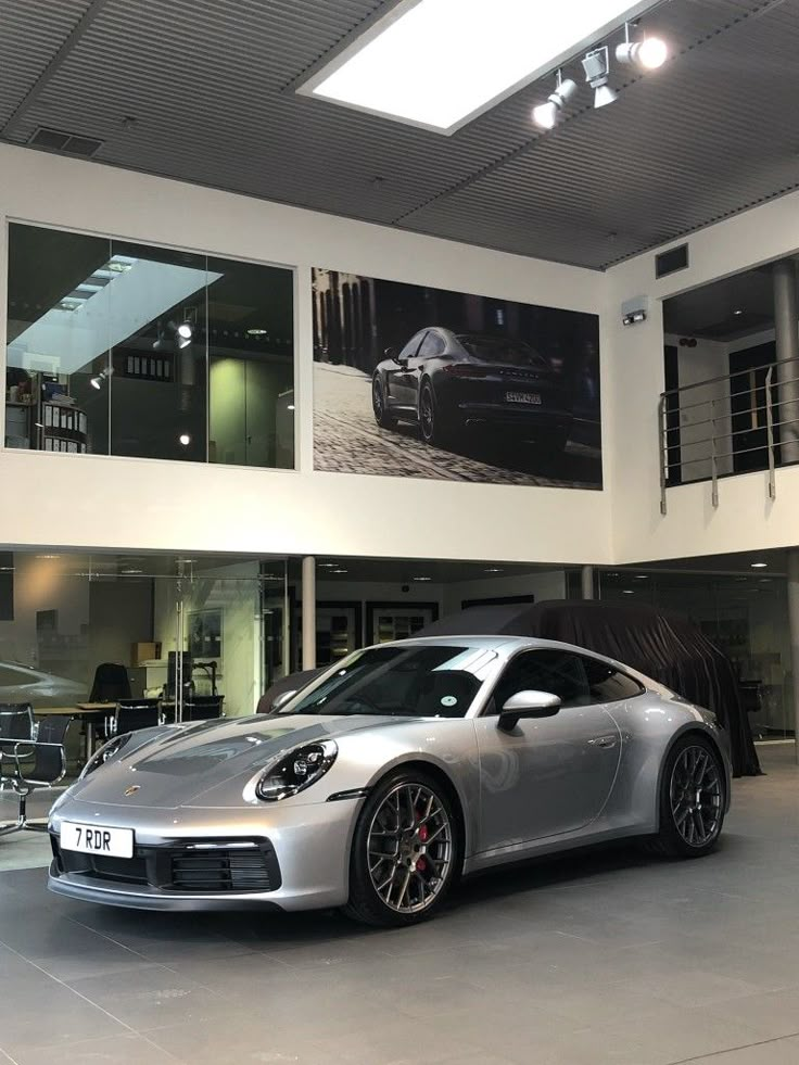 a silver sports car parked in a garage