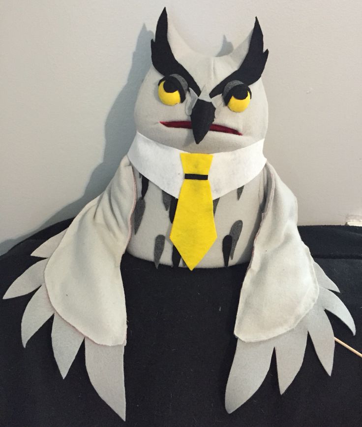 an owl wearing a yellow tie and black jacket