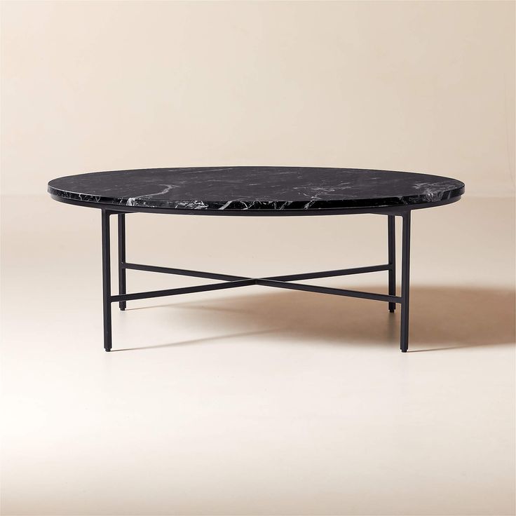 a black marble coffee table sitting on top of a white floor