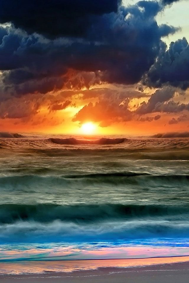 the sun is setting over the ocean with clouds in the sky and waves on the water