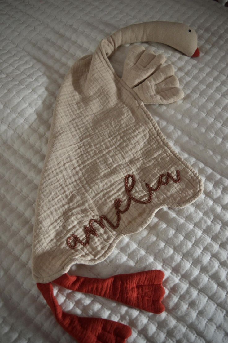 This charming hand-embroidered muslin goose baby lovey is the perfect blend of comfort and whimsy. The lightweight muslin fabric makes it easy for little hands to grasp and cuddle, while its generous size offers a cozy feel for nap time or on-the-go comfort. Ideal for soothing babies, this lovey is not only a delightful companion but also a cherished keepsake, making it an essential addition to any nursery. PERSONALIZATION: One or two names can be added to the lovey. Be sure to include what thread color you'd your name(s) to be stitched in. If no thread color choice is listed, the color from the original listing will be used. All names are lower case unless requested otherwise. Please be aware that the length of the name may change the size of the lettering in order for the name to fit pro Goose Lovey, Ringwood Nj, Baby Lovey, Homemade Baby, Blanket Personalized, Muslin Fabric, Baby Keepsake, Security Blanket, Personalized Baby Gifts