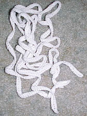 a white rope that is laying on the ground