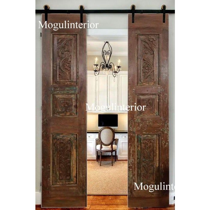 an open wooden door with the words mogulinttor and two chairs in front of it