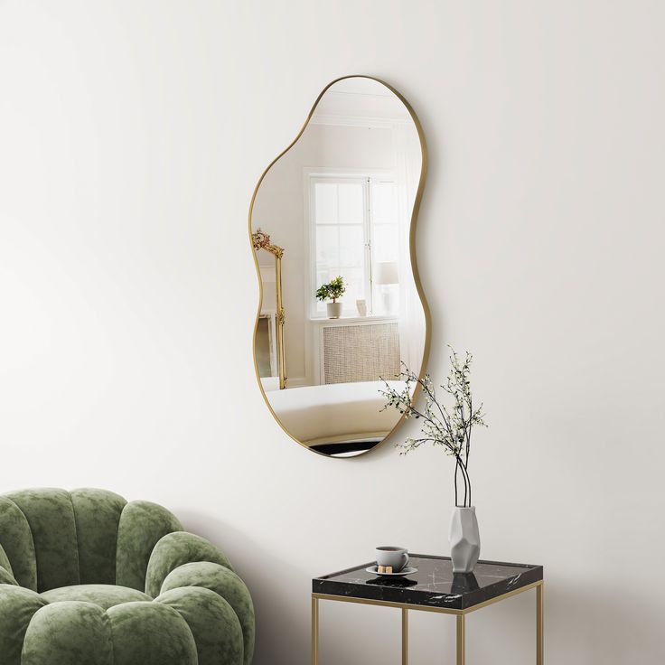 a living room with a green chair and mirror