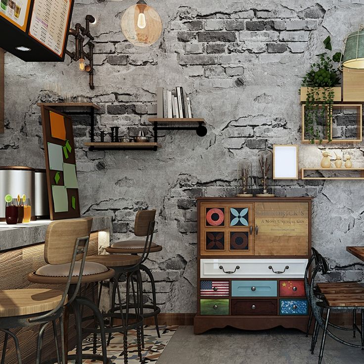 the interior of a restaurant with tables, chairs and an old brick wall behind it