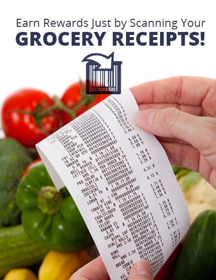 a hand holding a receipt in front of vegetables