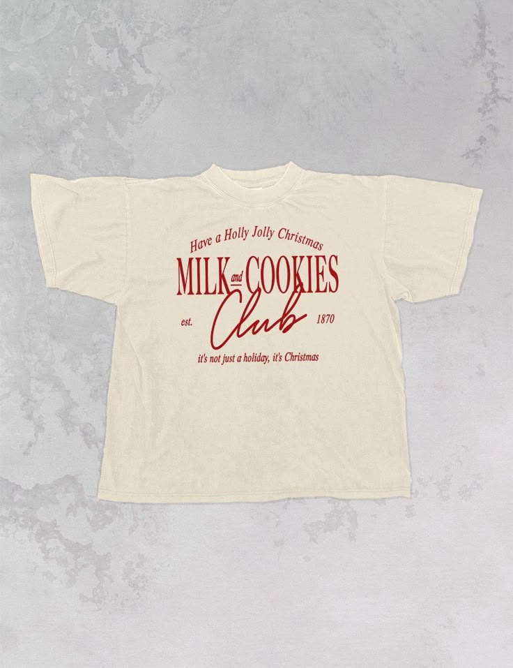 Join the Milk & Cookies club for everyone's favorite season, Christmas, in this super cozy oversized tshirt!- Features the phrase "Milk and Cookies Club, est. 1870" with "Have a Holly Jolly Christmas" above & "it's not just a holiday, it's Christmas" below all in red or white ink- Screen print transfer that is individually heat pressed onto each tshirt- Printed on a soft vintage wash tshirt, that gets softer with each wash- Oversized fit- 100% Cotton- Sizing translation: XS/S - L , S/M - XL , L/ Cool Christmas Tshirts, Italian T Shirts, Holiday Tshirt Designs, Staff Shirt Design, Fall T-shirt, Minimal Merch Design, Vintage Sports Tshirt, Christmas Graphic Tee, Christmas T-shirts