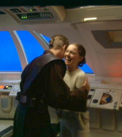 a man and woman standing next to each other in front of a machine with buttons on it