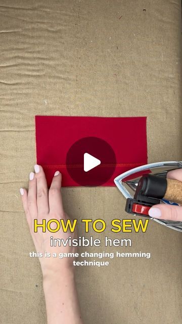 a woman is making a red piece of paper with her hands and the words how to sew invisible hem