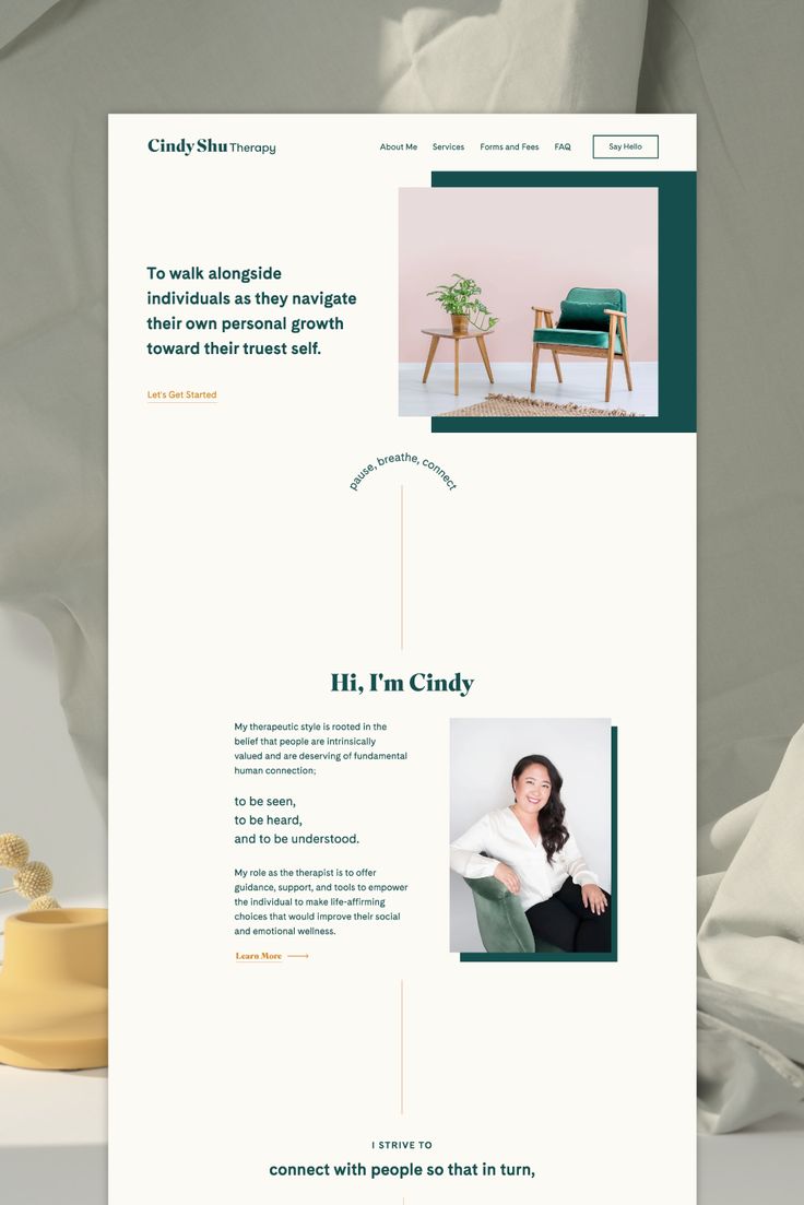 an image of a web page for a furniture store that is on the table next to a chair and potted plant