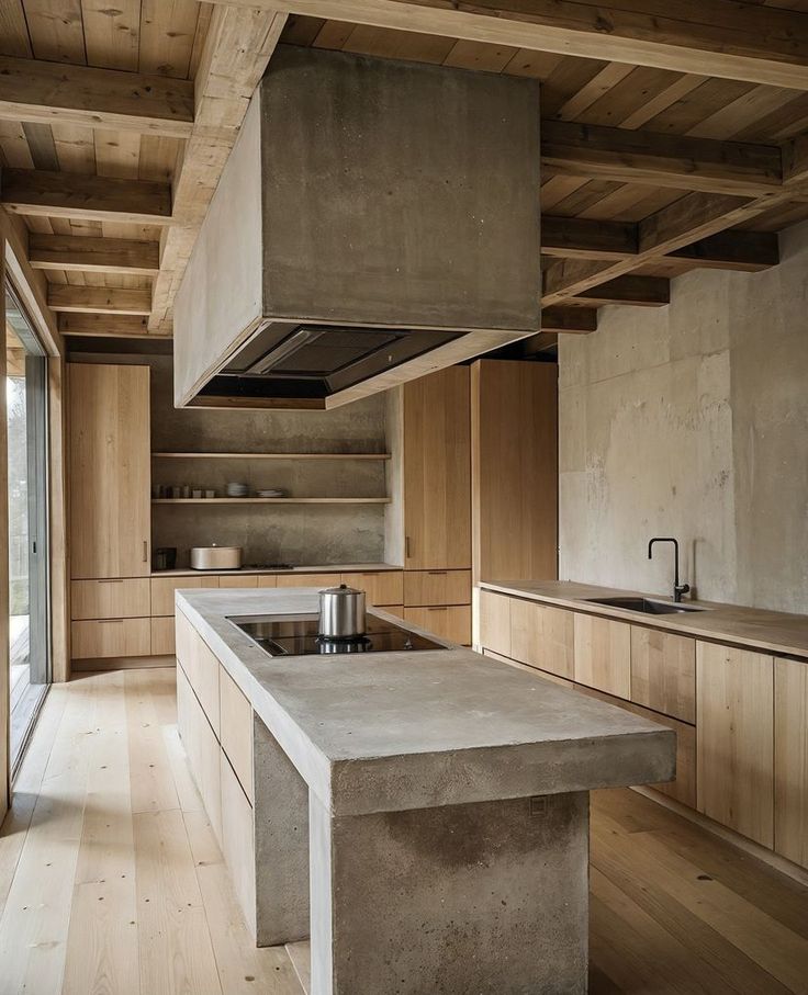 a kitchen with an island counter top and wooden cabinets in the center, surrounded by wood flooring