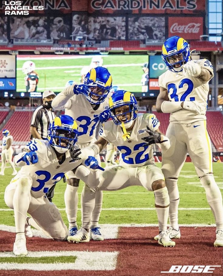 a group of football players standing on top of a field