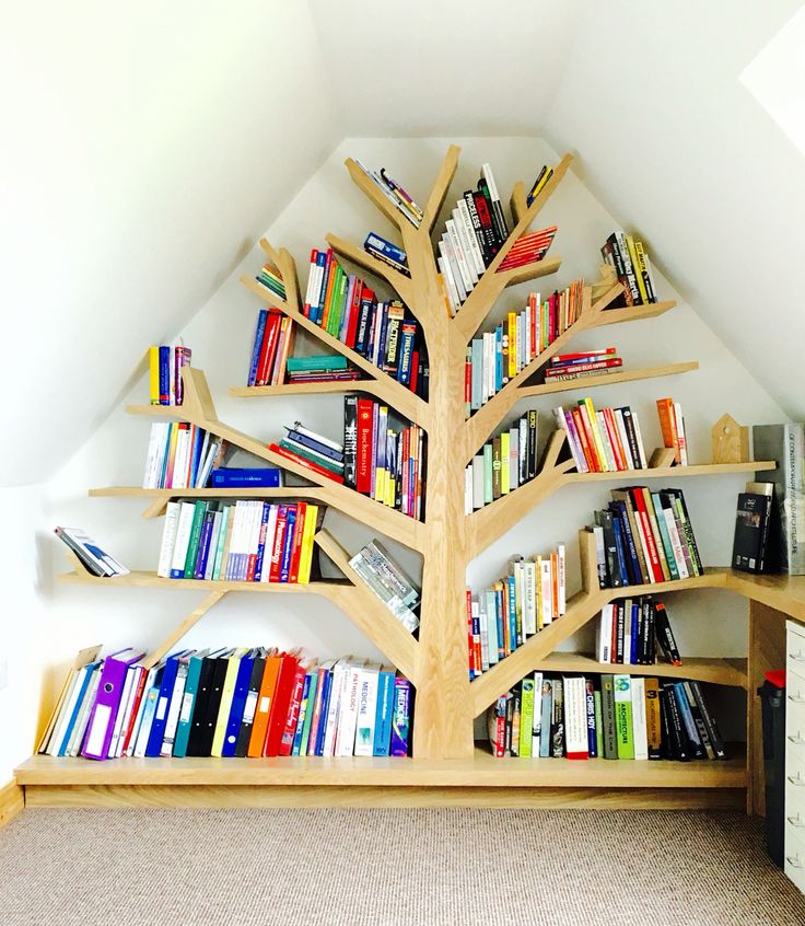 a bookshelf in the shape of a tree with many books on it,