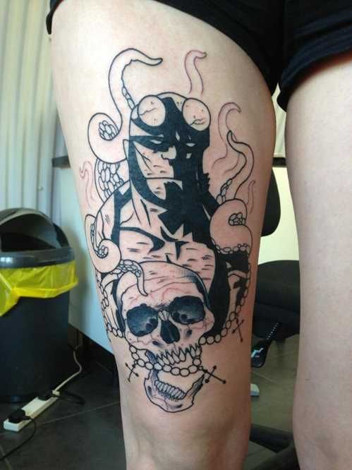 a woman's leg with a tattoo on it and an image of a skull