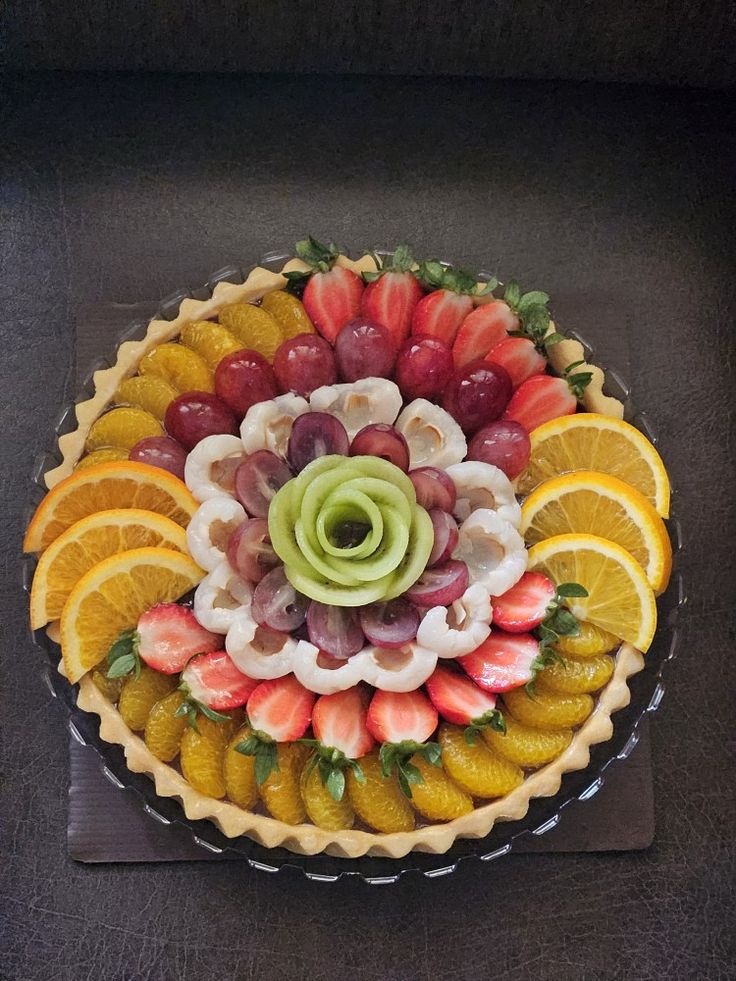 a fruit and vegetable pie on top of a wooden table