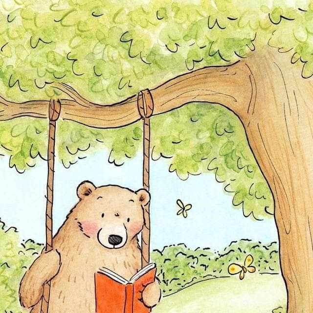 a bear is sitting on a swing reading a book