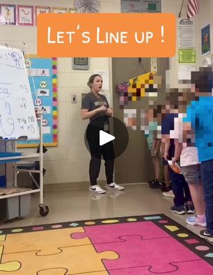 a group of children standing in front of a whiteboard with the words let's line up