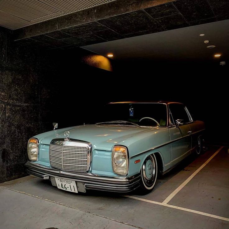 a blue car parked in a parking garage